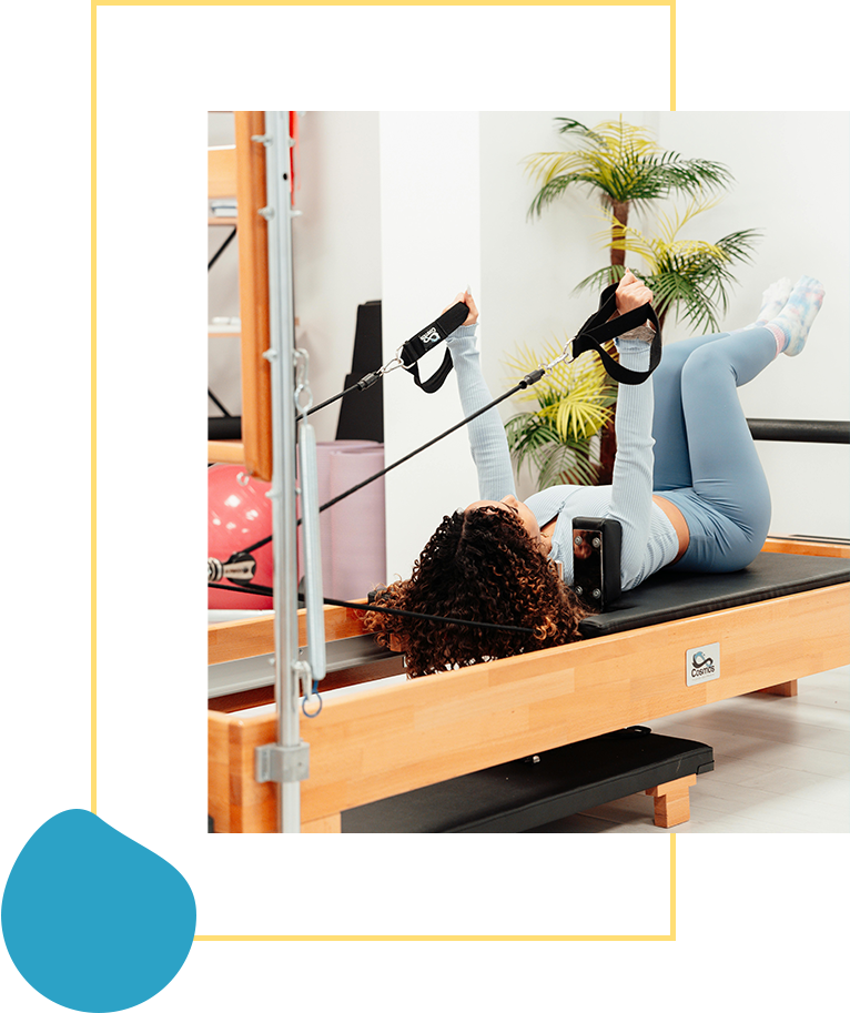 A woman is on the pilates machine