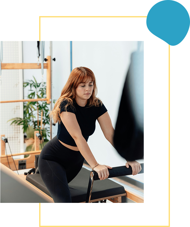 A woman is sitting on the rowing machine