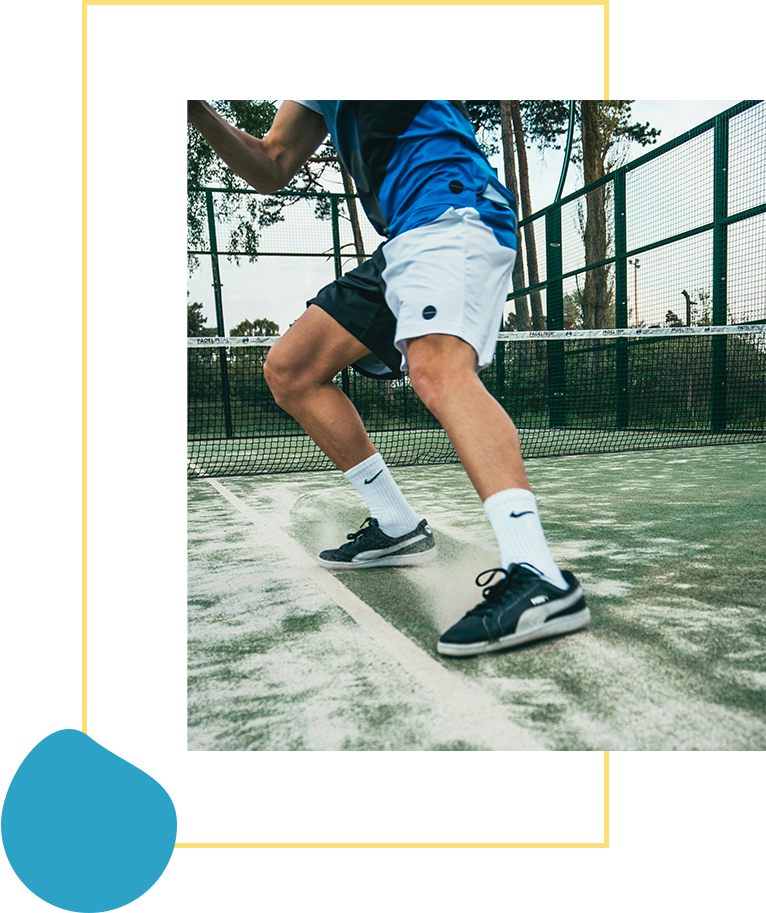 A man is playing tennis on the court